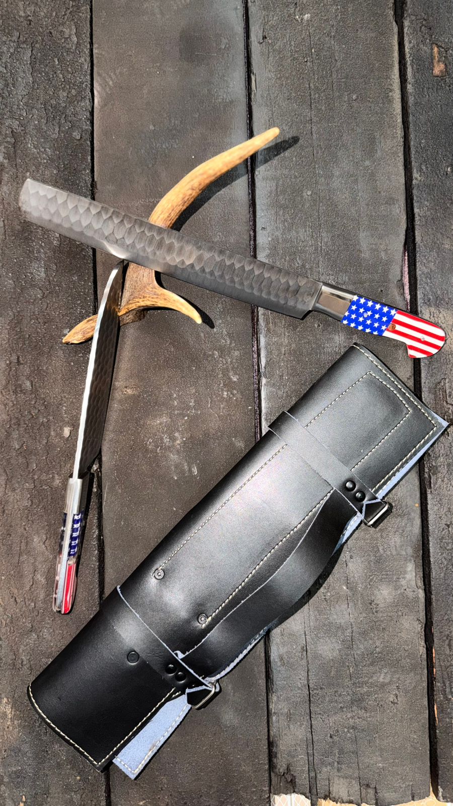 Black leather archery quiver with bow and American flag design on a wooden surface
