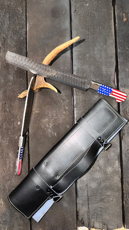Black leather archery quiver with bow and American flag design on a wooden surface