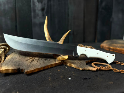 Knife with a white handle on a dark surface with antlers and rope