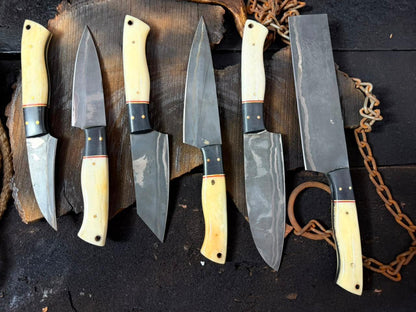 Set of knives with wooden handles on a dark surface