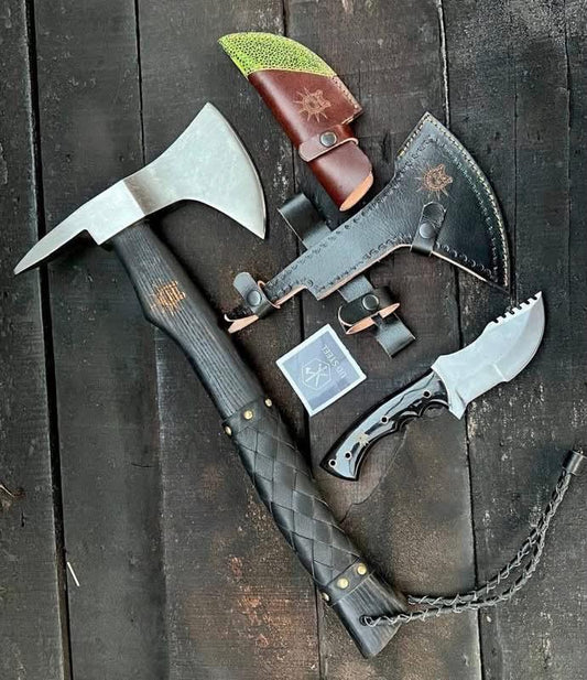 Two axes and a knife on a wooden surface