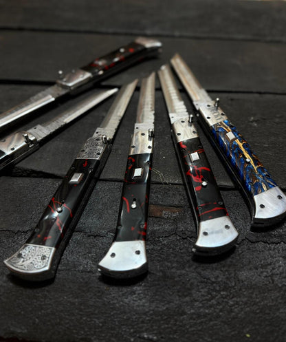 Set of decorative knives with artistic handles on a dark surface