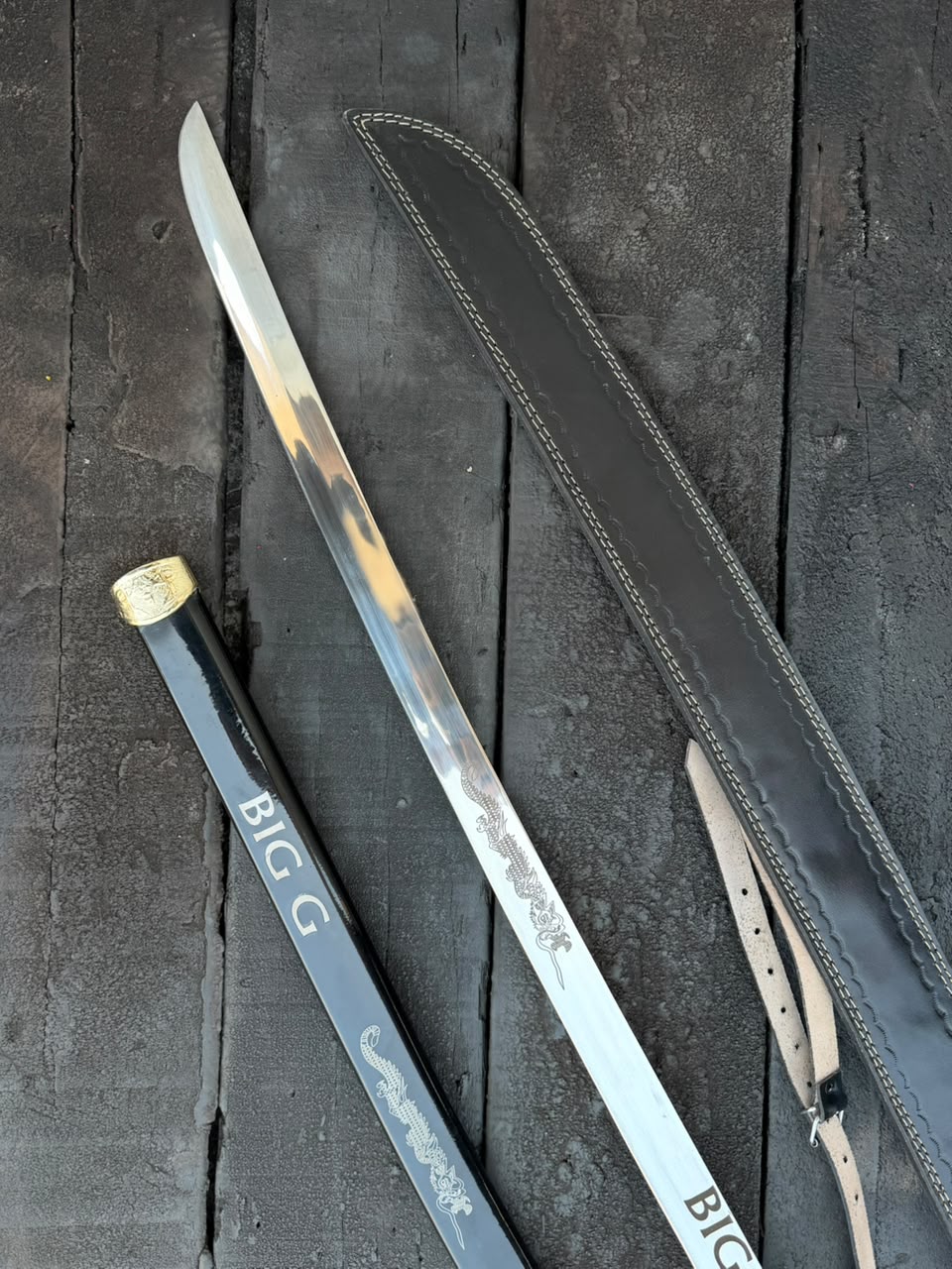 Sword with sheath on a dark wooden surface
