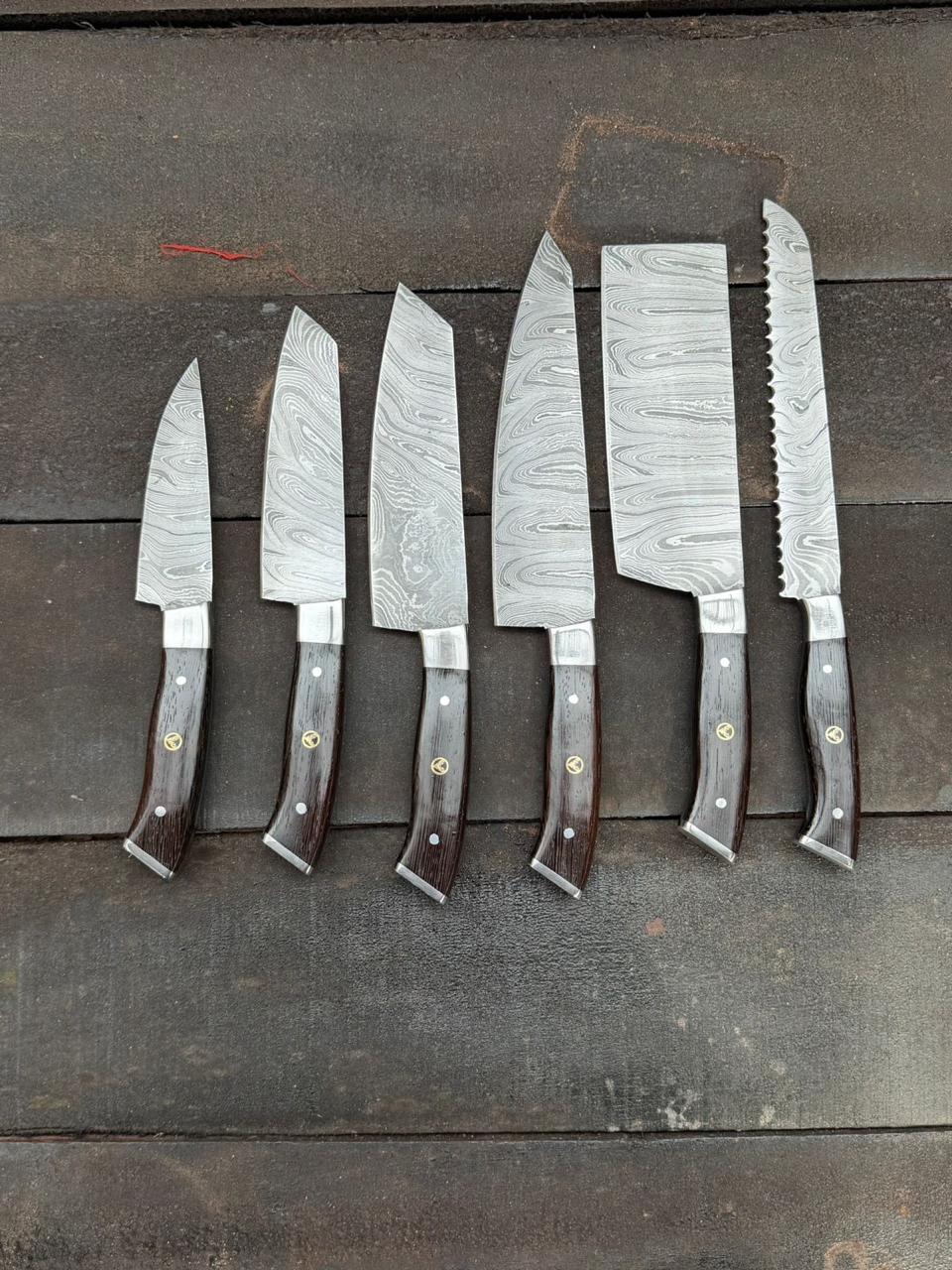 Set of six Damascus knives with wooden handles on a wooden surface