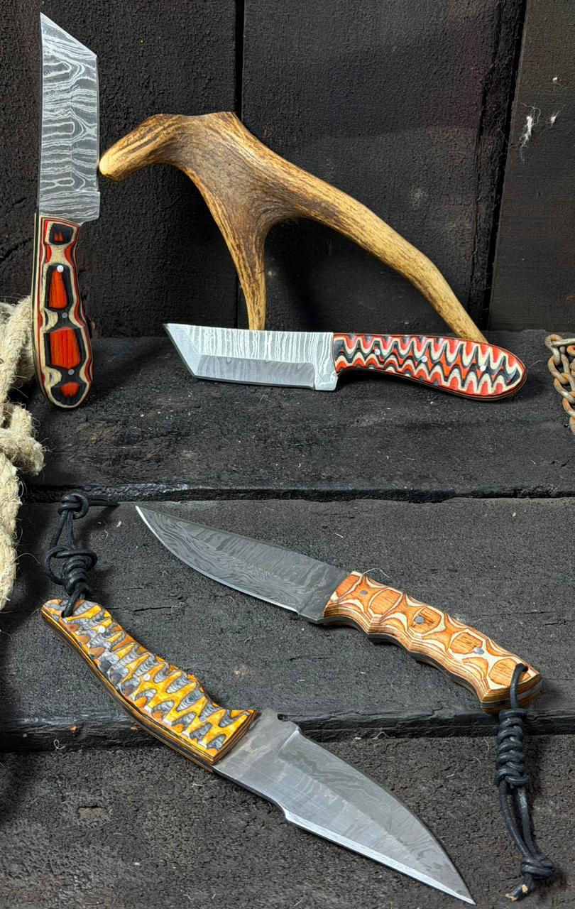 Four knives with decorative handles on a dark wooden surface