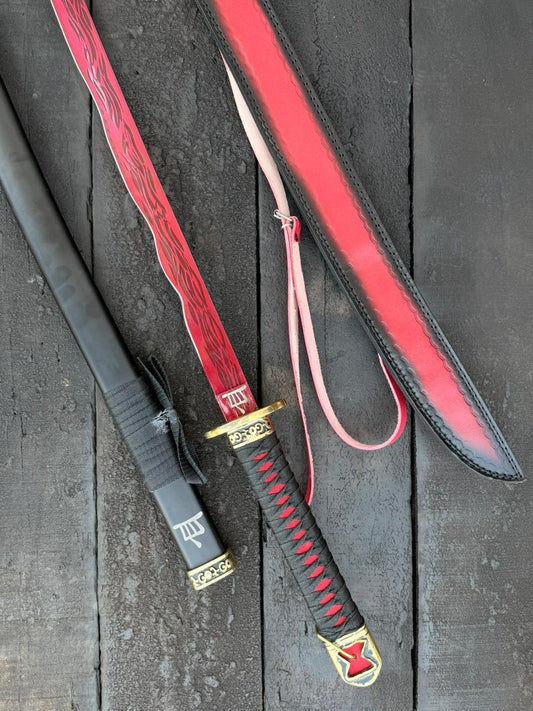 Sword with red sheath on a textured black surface