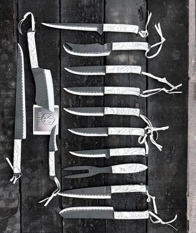 Set of knives with sheaths arranged on a wooden surface