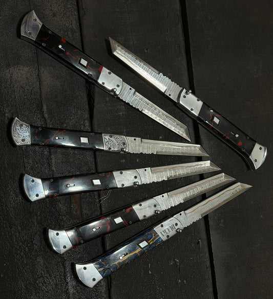 Set of folding knives with decorative handles on a dark surface