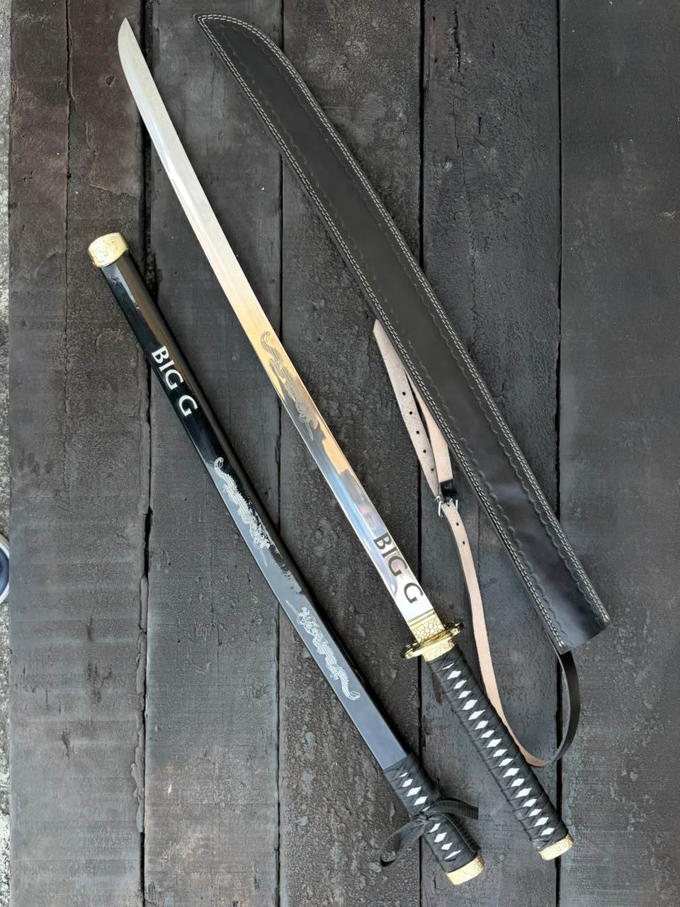 swords with sheaths on a dark wooden surface