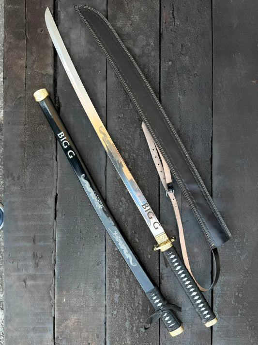 swords with sheaths on a dark wooden surface
