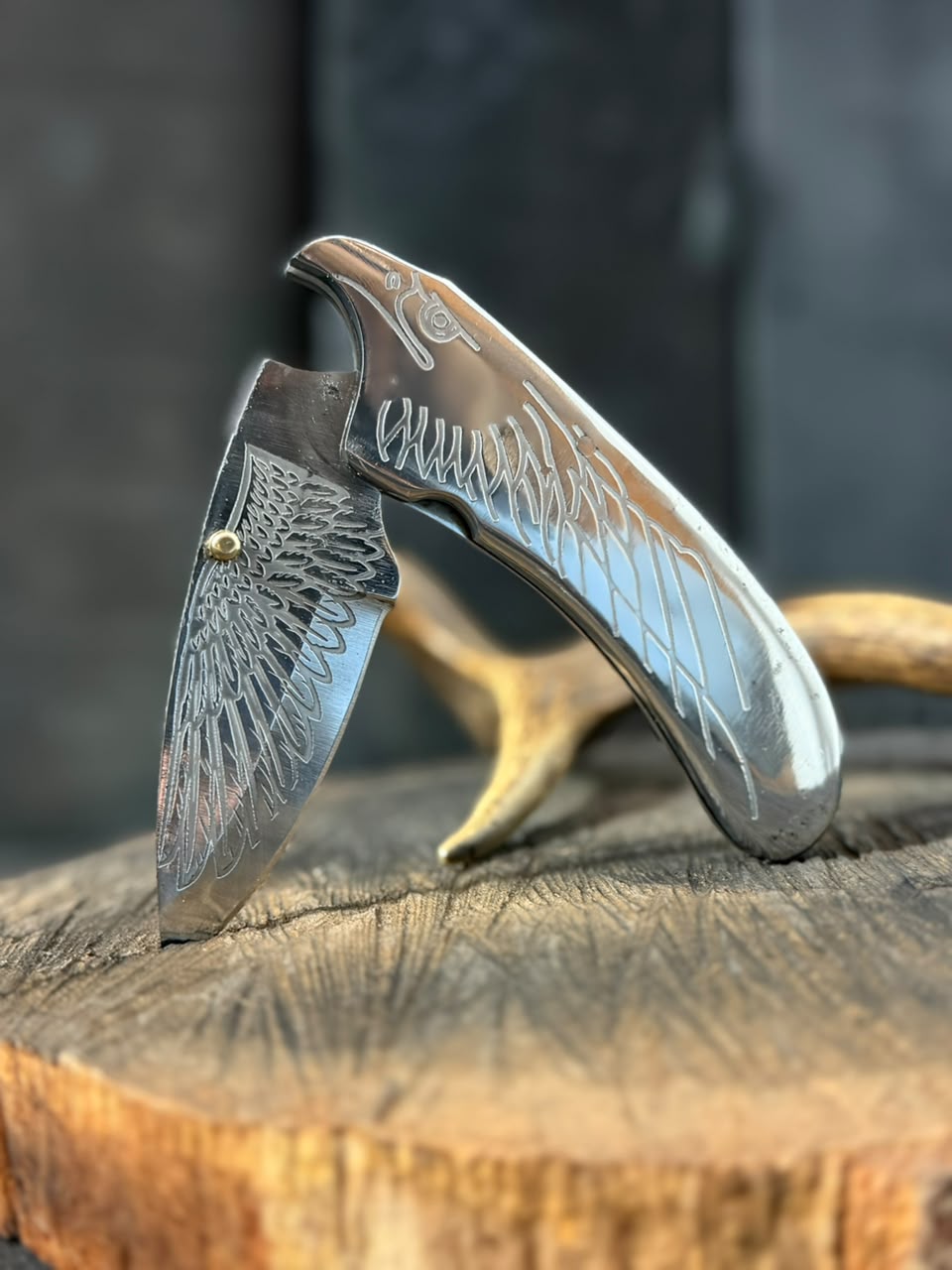 Decorative pocket knife with engraved design on a wooden surface