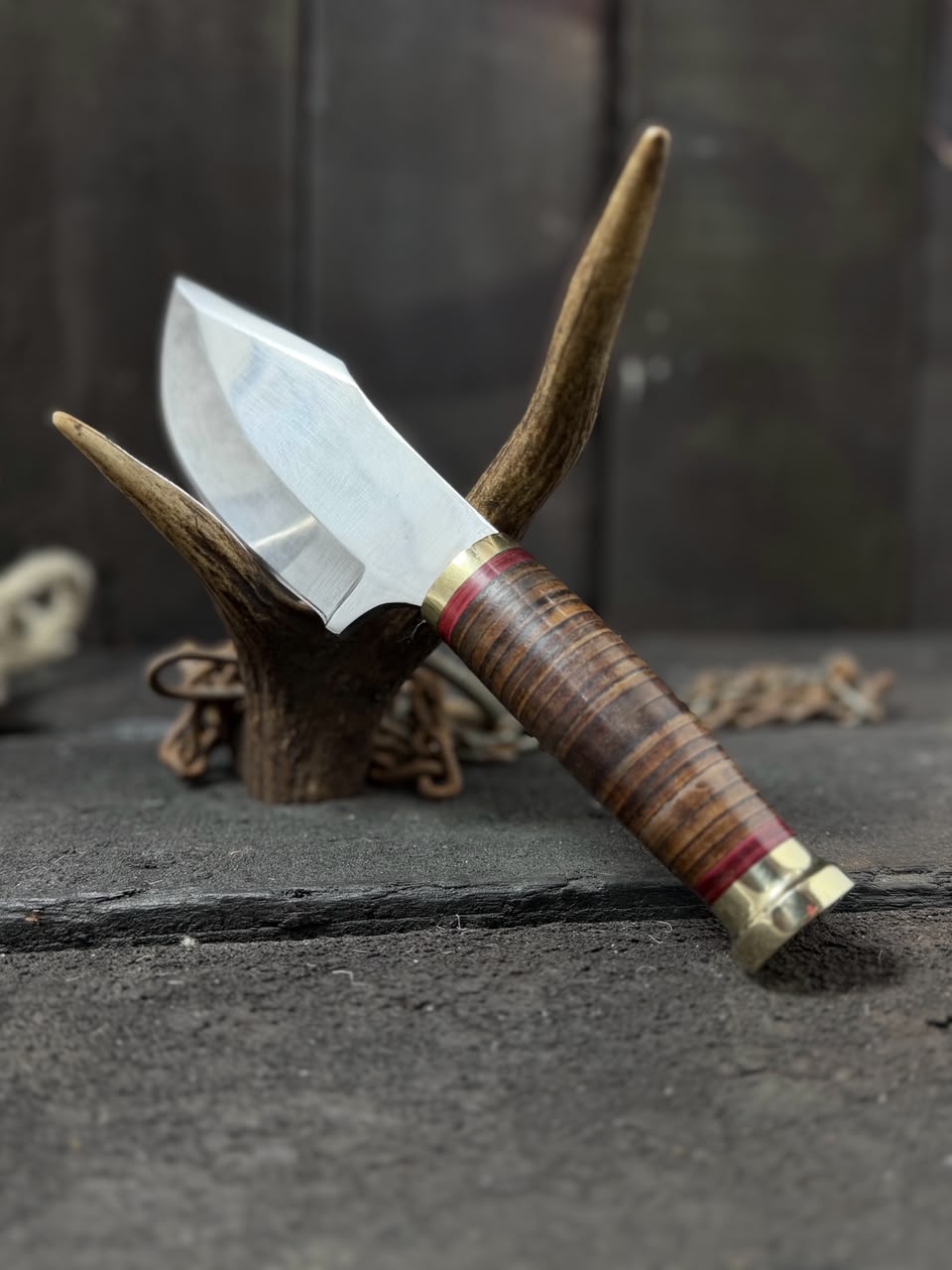 Knife with wooden handle and metal blade on a dark surface