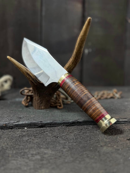 Knife with wooden handle and metal blade on a dark surface