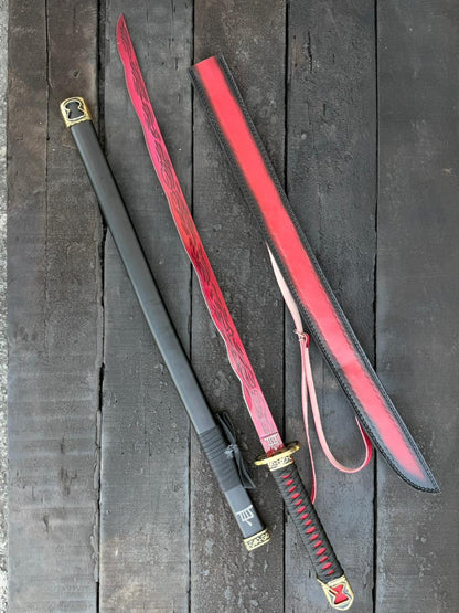Sword with red sheath on a wooden surface