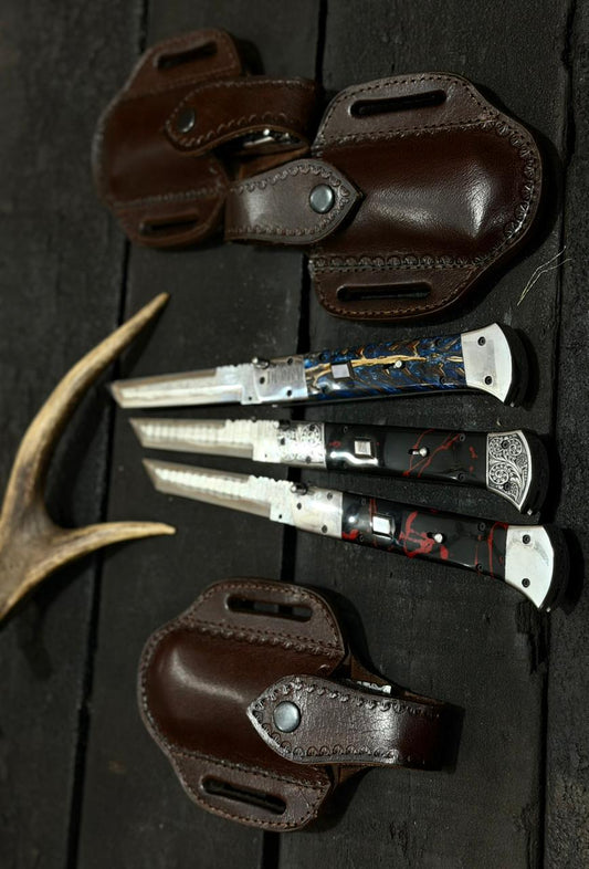 Set of knives with leather sheaths on a dark wooden surface
