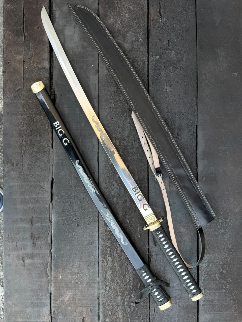  swords with sheaths on a dark wooden surface