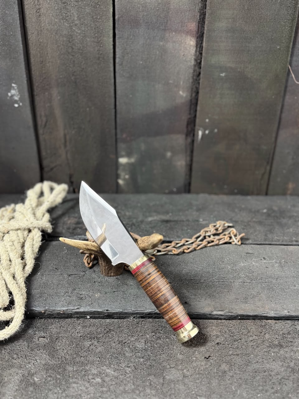 Knife with a wooden handle and metal blade on a dark surface