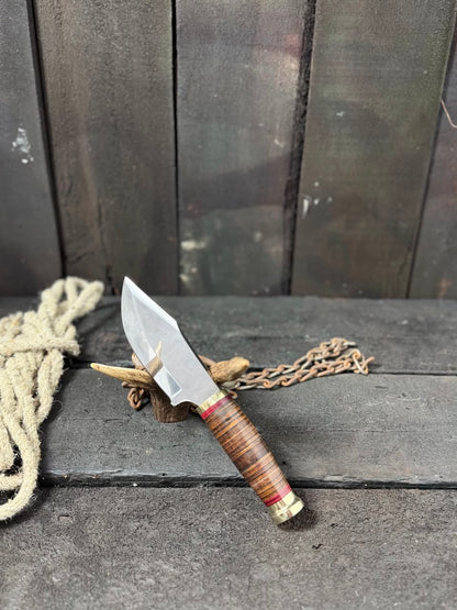 Knife with a wooden handle and metal blade on a dark surface