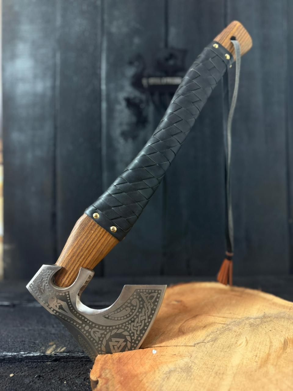 Decorative axe with a braided handle on a wooden surface