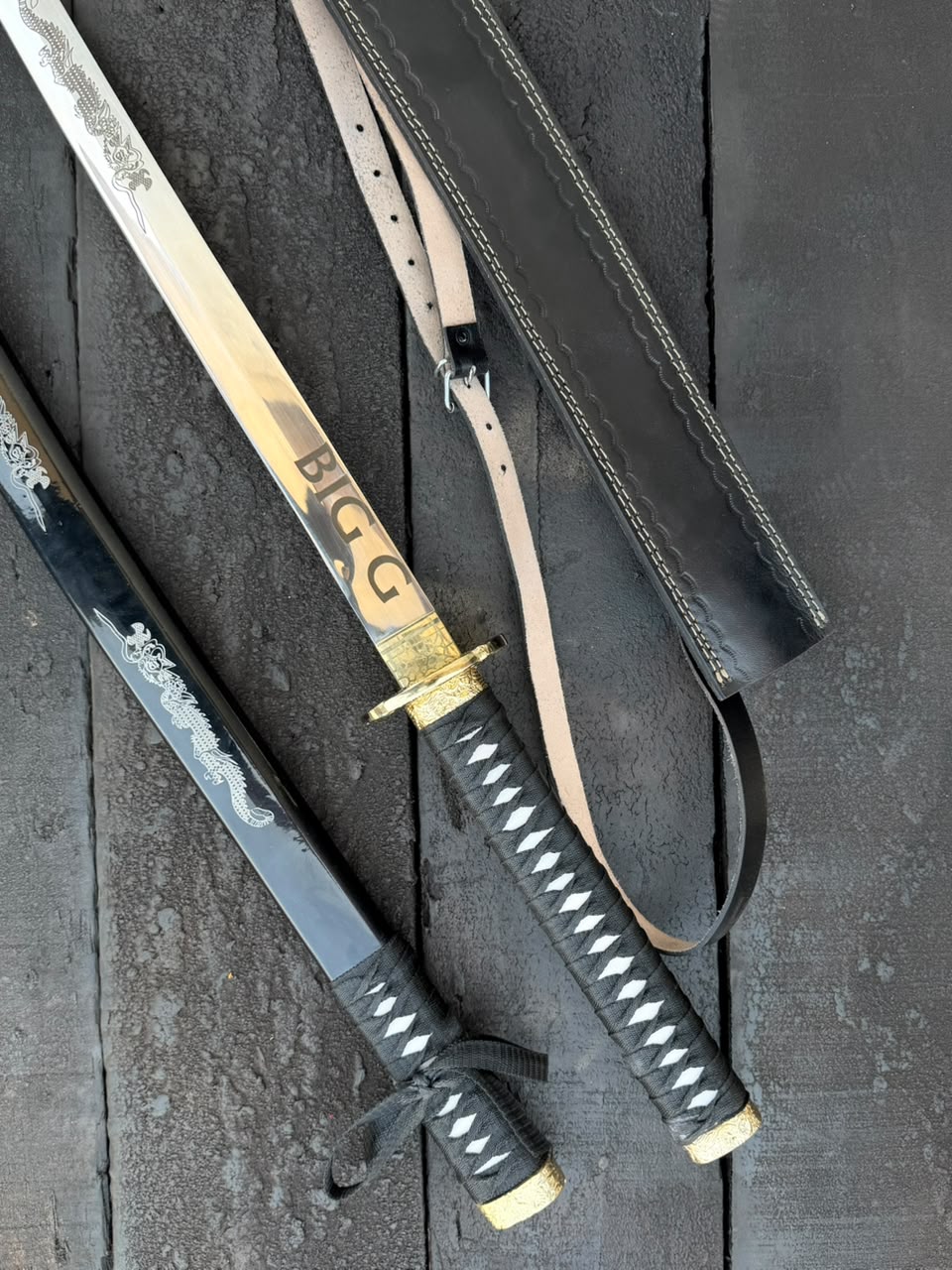 swords with gold accents on a dark wooden surface