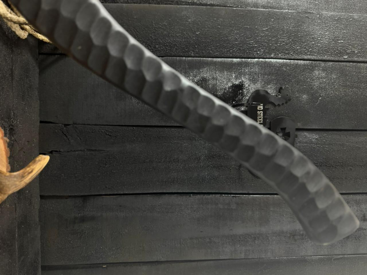 Close-up of a textured blade against a wooden background
