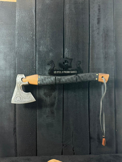 Axes with wooden handles on a black background