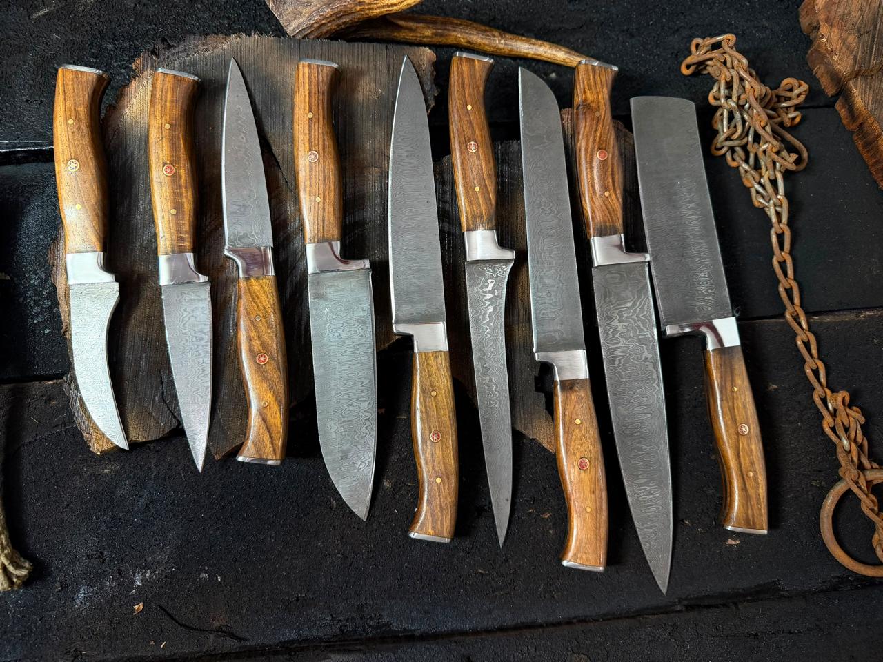 Set of knives with wooden handles on a dark surface