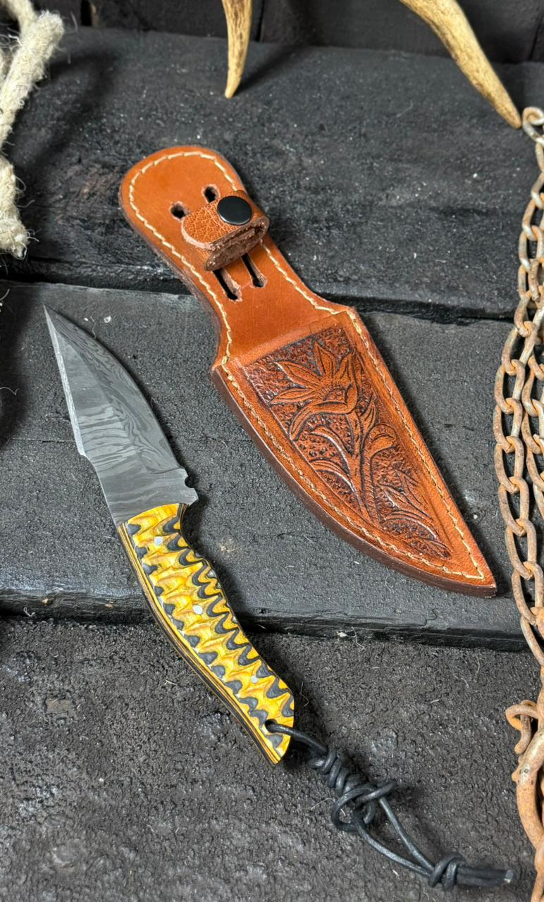Knife with a decorative sheath on a textured surface
