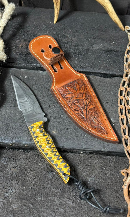 Knife with a decorative sheath on a textured surface