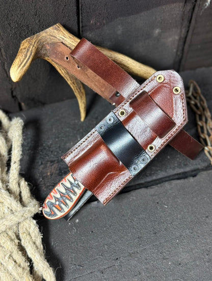 Brown leather knife sheath with decorative pattern on a dark background