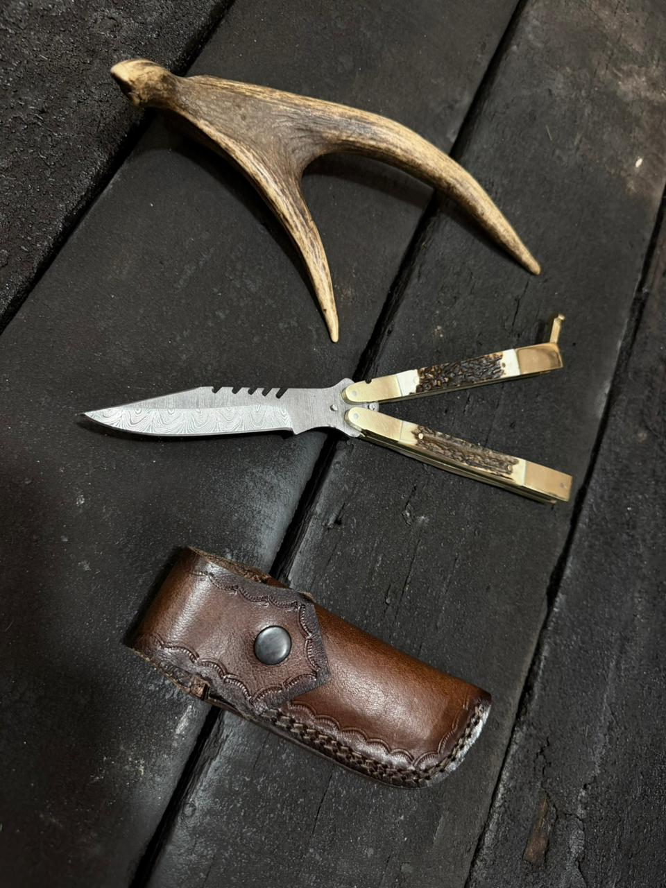 Knife with wooden handle and leather sheath on a dark wooden surface
