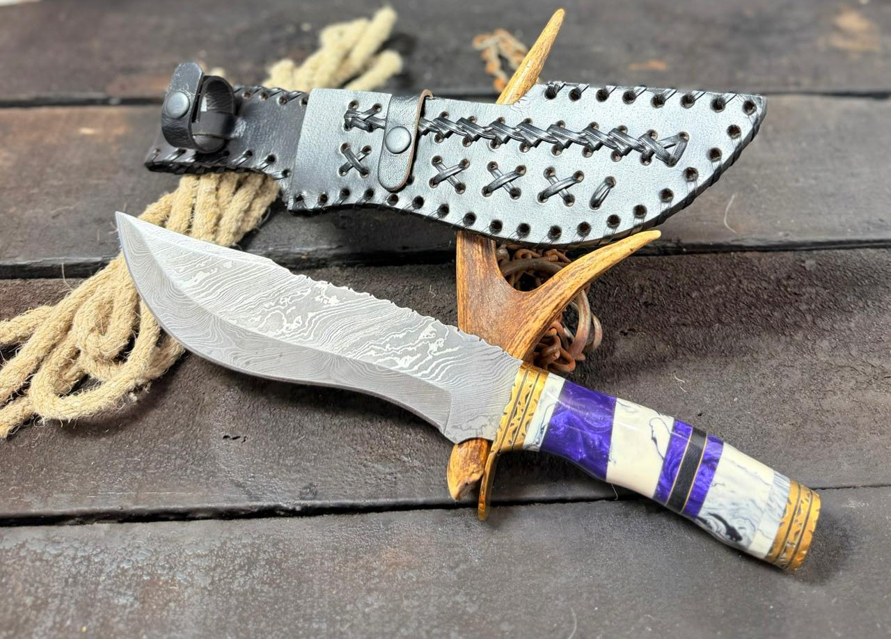 Damascus knife with a resin handle and leather sheath on a wooden background