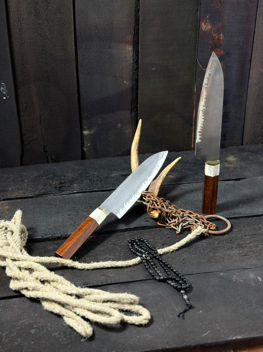 Two knives with wooden handles on a dark surface with a rustic background.
