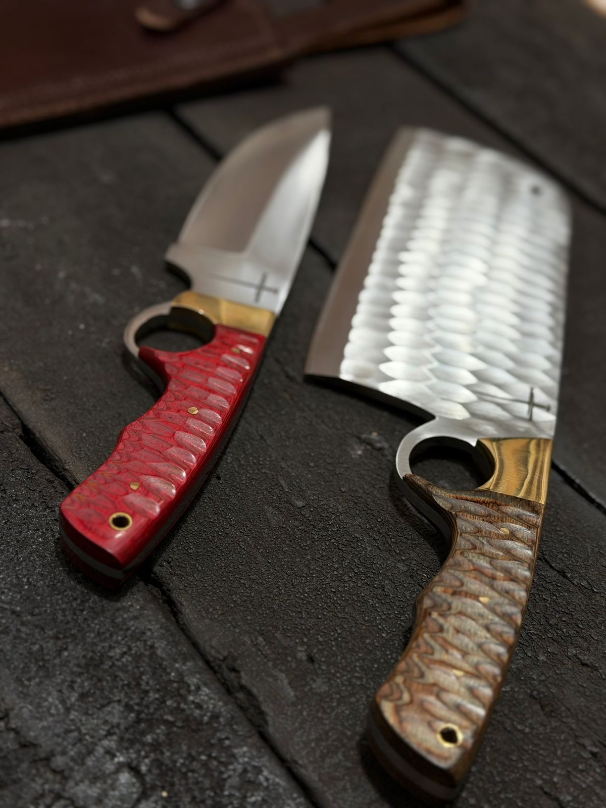 Two knives with different handles on a dark surface