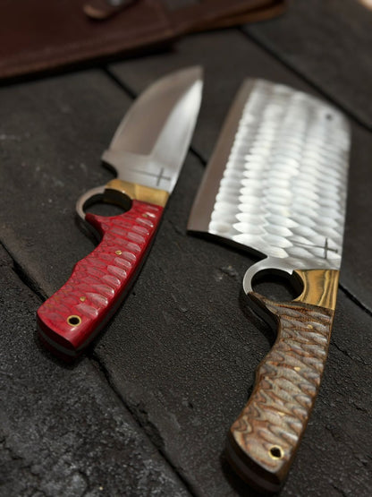 Two knives with different handles on a dark surface
